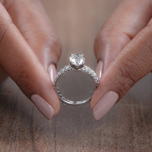 close view of oval-cut lab diamond bridal engagement ring set with white gold band