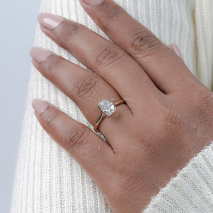 oval lab diamond button back solitaire engagement ring worn on finger