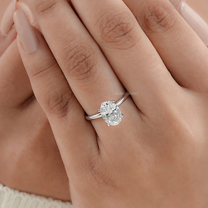 igi certified oval cut diamond solitaire engagement ring on model's hand