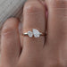 front view of oval and pear cut lab diamond toi et moi engagement ring in finger