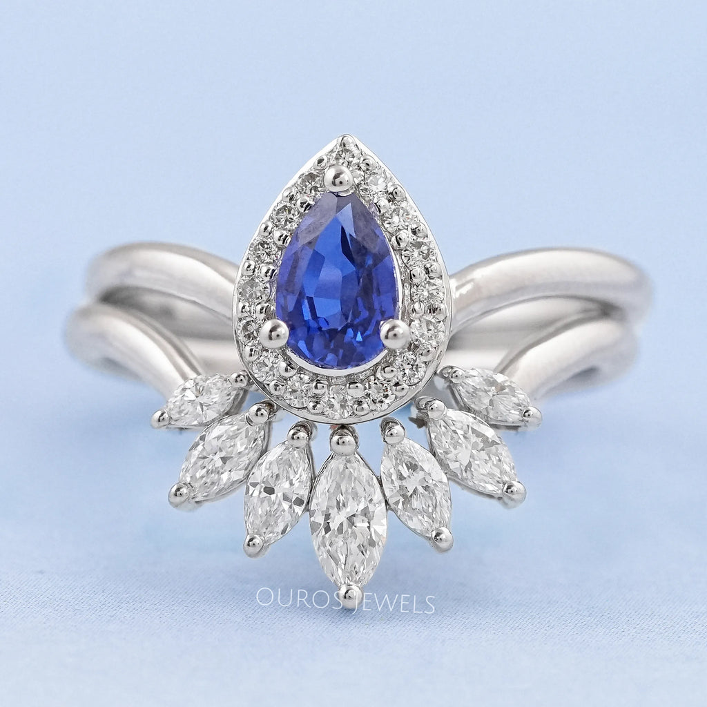 front view of sapphire pear gemstone with marquise diamond carved wedding band