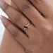garnet pear-cut gemstone engagement ring in finger