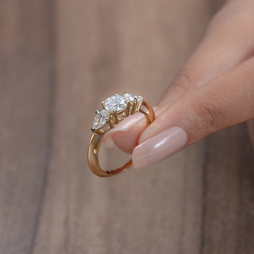 side view of 3 stone round cut lab diamond engagement ring with yellow gold band