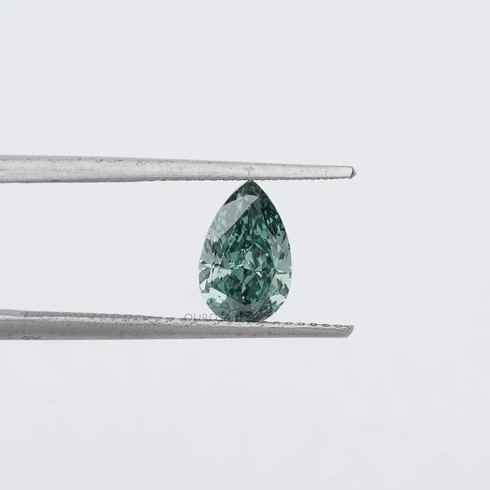 1.62 Carat Fancy Vivid Green Pear Cut Lab Grown Diamond hold by metal tweezers against a plain white background.