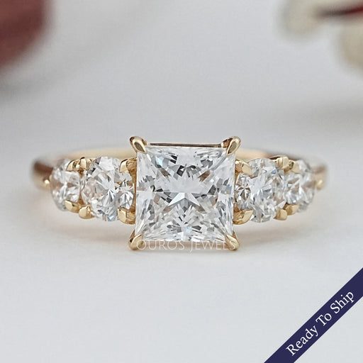front view of princess cut diamond five stone engagement ring in yellow gold band
