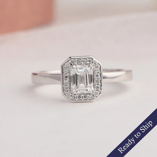 Emerald cut lab grown diamond engagement ring with sparkling halo of round diamonds in 14k white gold