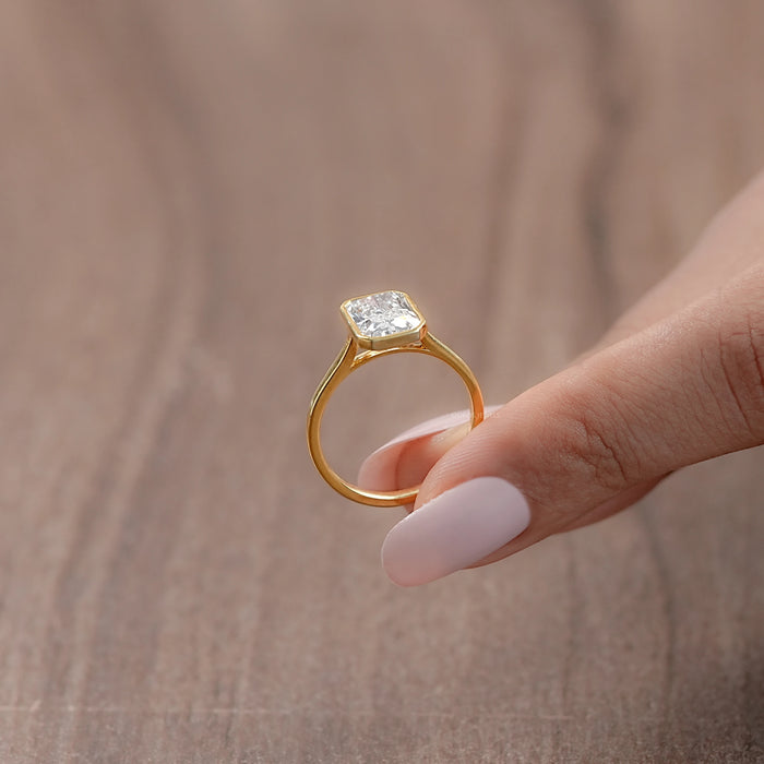 side angle view of radiant lab diamond bezel set engagement ring