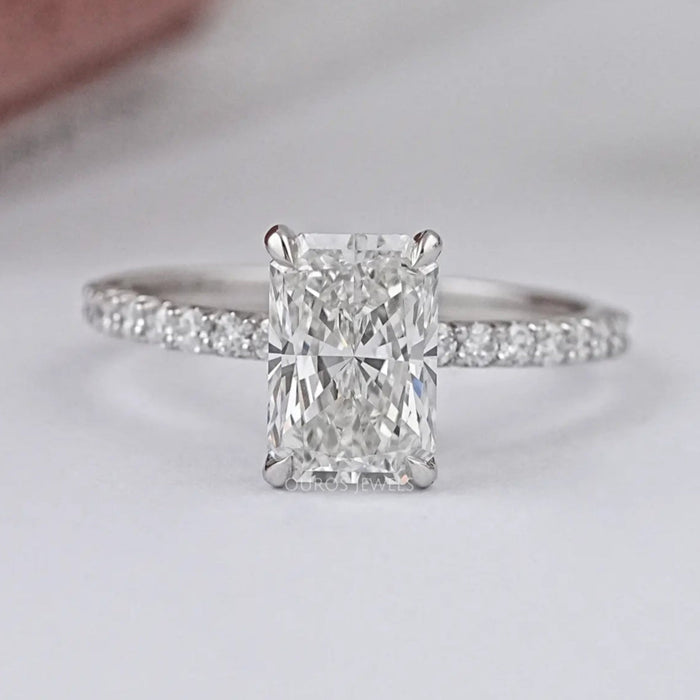 front view of radiant-cut lab diamond solitaire accent engagement ring on grey fabric