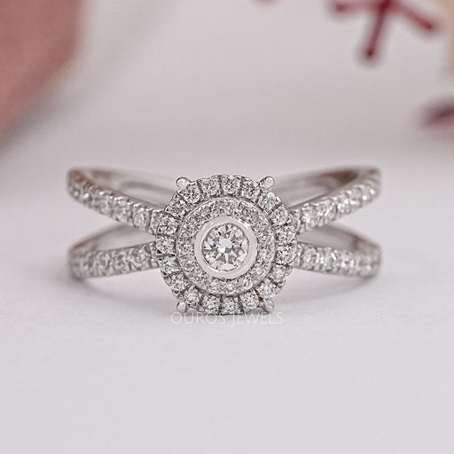 front view of round cut lab diamond halo crossover ring on grey fabric