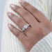 round cut diamond five stone engagement ring with white gold band on model's finger