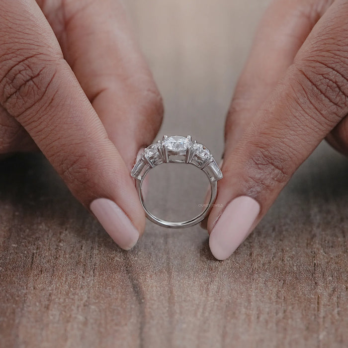 close view of round cut diamond five stone engagement ring with white gold band