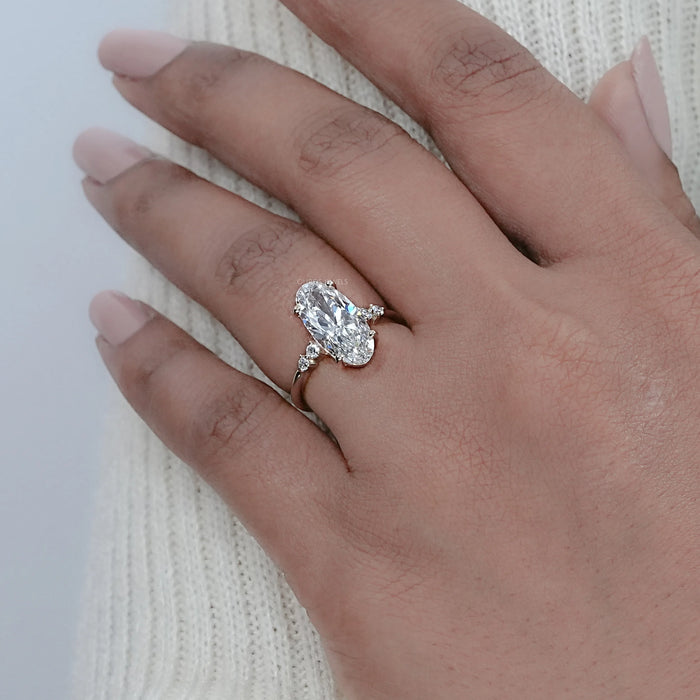 moval cut lab-grown diamond solitaire accent engagement ring on model's finger