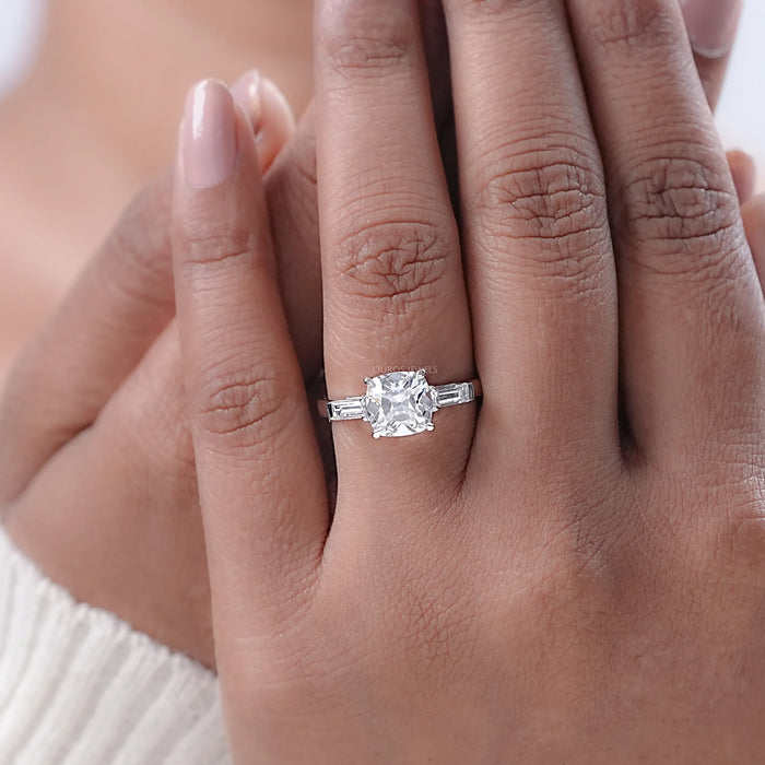 square old mine cushion cut diamond 3 stone engagement ring in model's finger