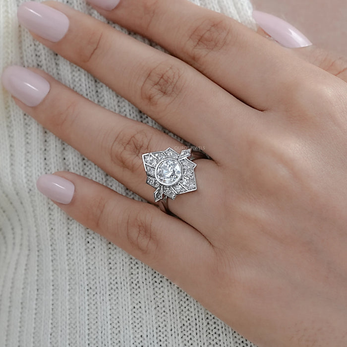 old european round cut diamond bezel set engagement ring in finger