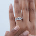 emerald cut diamond five stone engagement ring with white gold band in finger