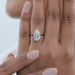front view of pear cut lab diamond solitaire engagement ring in finger