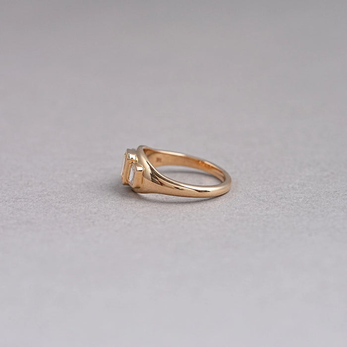 side view of yellow emerald-cut diamond 3 stone bezel set colored engagement ring