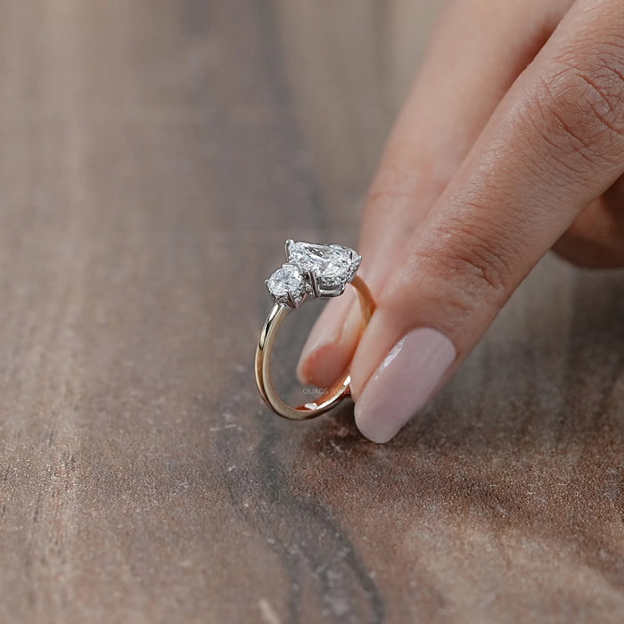 side view of three stone pear cut diamond hidden halo engagement ring