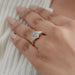 blue hexagon-cut lab diamond halo 3-stone colored engagement ring in finger