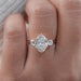 front view of oval cut lab grown diamond three stone engagement ring in finger