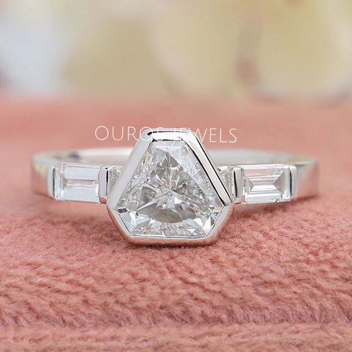 front view of three stone shield cut diamond bezel set engagement ring
