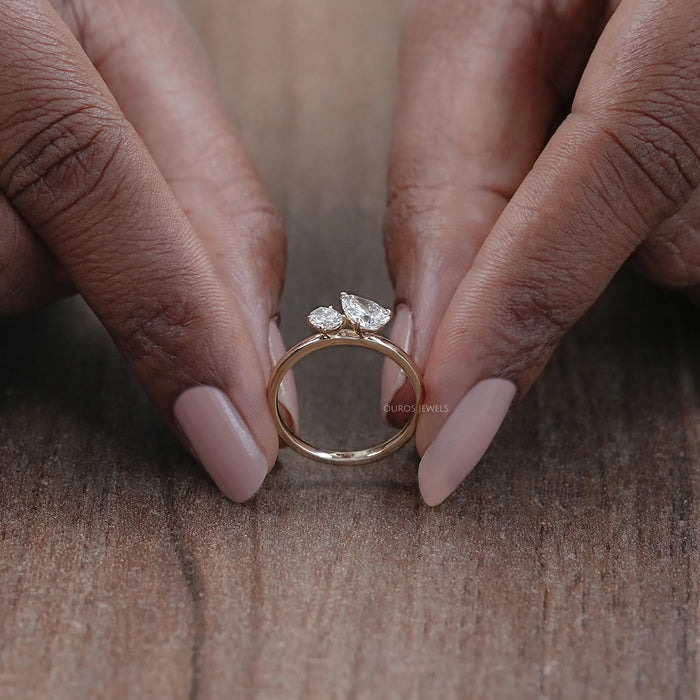 close view of oval and pear cut lab diamond toi et moi engagement ring