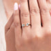 oval and emerald-cut lab diamond toi et moi engagement ring on model's finger