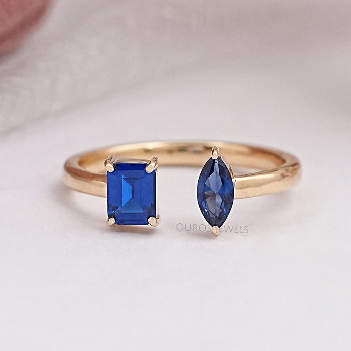 front view of two stone blue emerald and pear gemstone open cuff wedding band