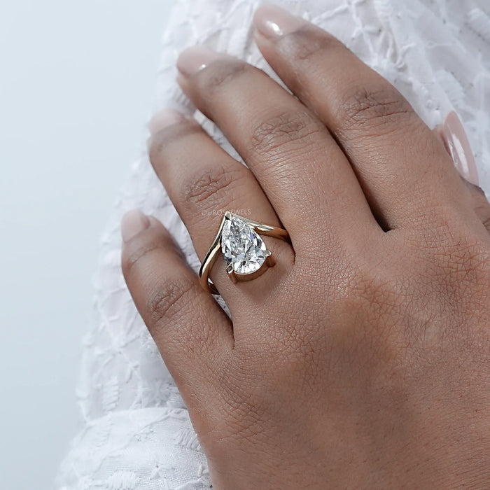 v shape pear cut lab diamond solitaire engagement ring in finger