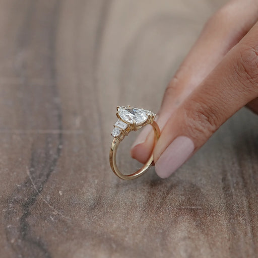 side view of pear and baguette cut lab diamond five stone engagement ring