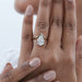 v shape pear cut lab diamond solitaire engagement ring on model's finger