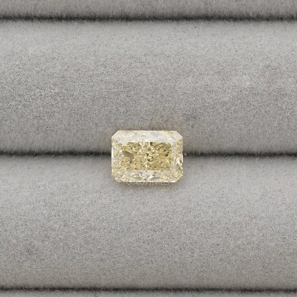 2.15 Carat Fancy Intense Yellow Radiant Cut Lab Diamond displayed on a grey velvet jewelry tray.