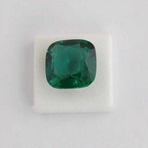 dark zambian green cushion cut man made gemstones on white fabric