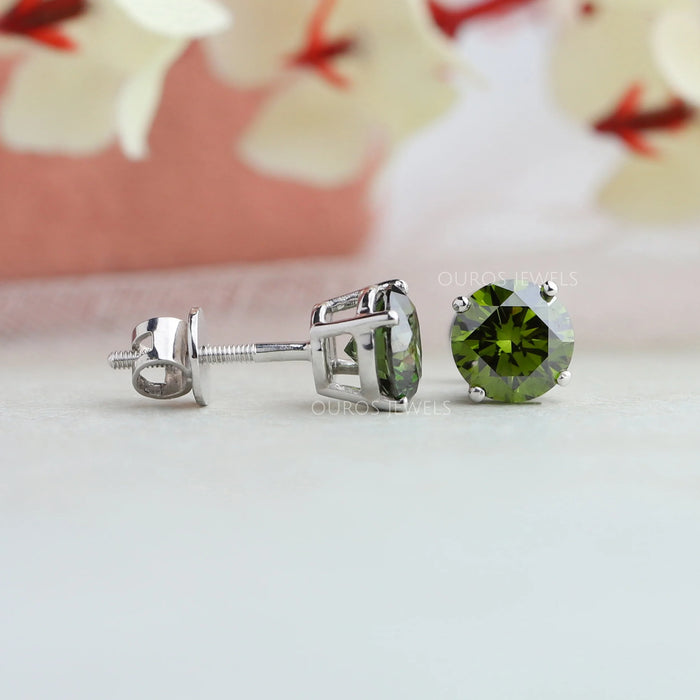 side and top view of green round cut man made diamond stud earrings white gold