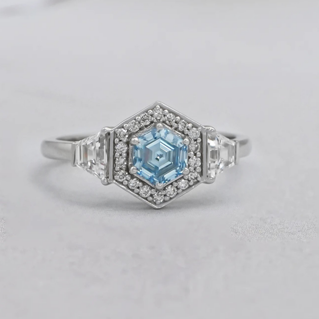 hexagon cut diamond halo three stone ring 