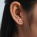 pink radiant cut halo diamond stud earrings rose gold on model's ear