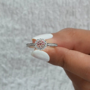 A Women holding a Pink Round Halo Setting Ring.