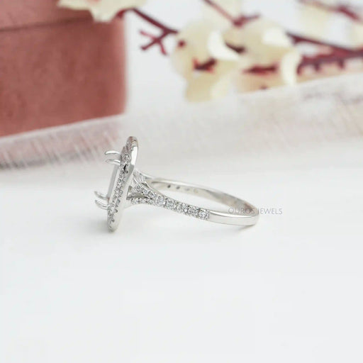 side view of princess-cut semi-mount double halo engagement ring on fabric