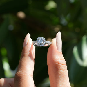 [ a women holding a round engagement ring]-[Ouros Jewels]