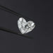 1 Carat IGI Certified Heart Cut Lab Grown Diamond hold by black tweezers against a dark background, highlighting its precision cut and sparkling facets.