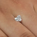 1 Carat IGI Certified Heart Cut Lab Grown Diamond placed on a finger, emphasizing its sparkling clarity and heart-shaped brilliance against the skin.