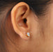 A women wearing Asscher Cut Diamond Two Tone Stud Earrings.