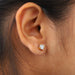 A women wearing a Asscher Cut Diamond Two Tone Stud Earrings.