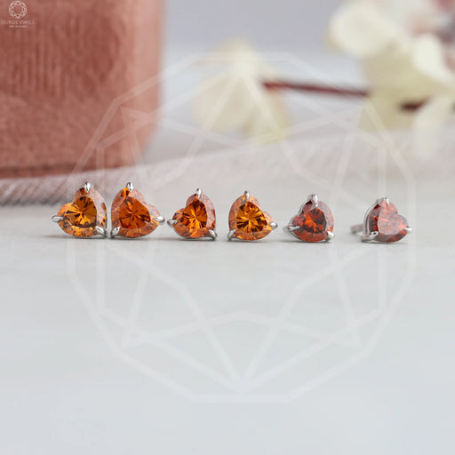 top view of red heart shaped diamond screw back stud earrings white gold