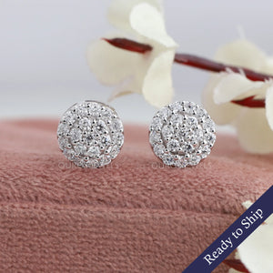 Front view of round stud earrings set in halo style, in 14k white gold.