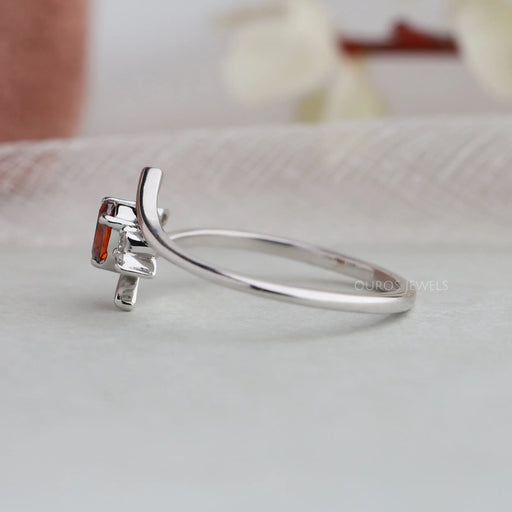 side view of red oval-cut lab-grown diamond bypass colored wedding band