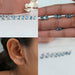 Blue Oval Cut Lab Diamond Stud Earrings in a collage: top left showing multiple pairs on a white surface, top right held in a hand, bottom left worn on an ear, and bottom right arranged with their backs visible.