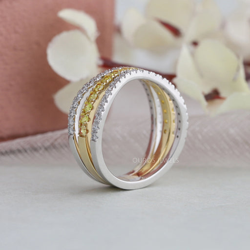 close view of yellow round-cut lab diamond triple-shank cluster engagement ring