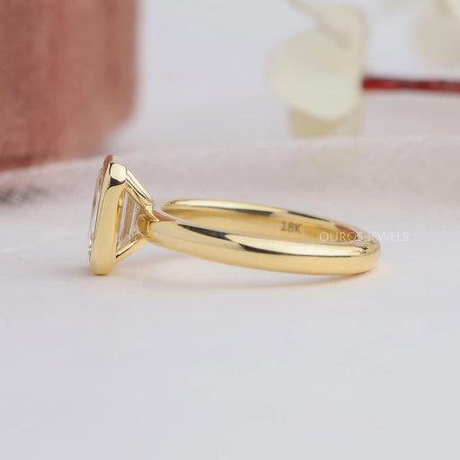 side view of emerald cut diamond bezel set solitaire engagement ring