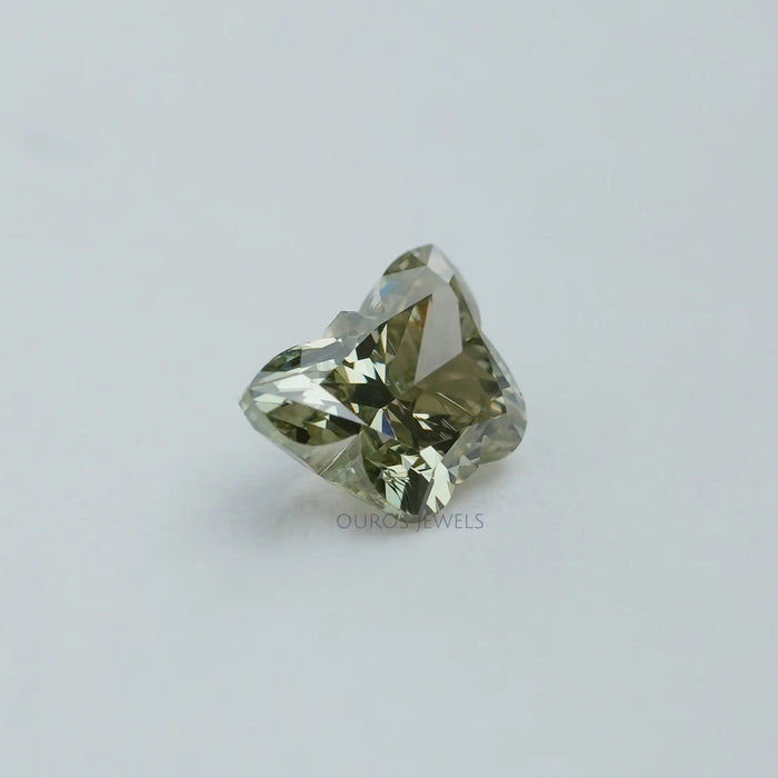 green colored diamond on the plain white surface